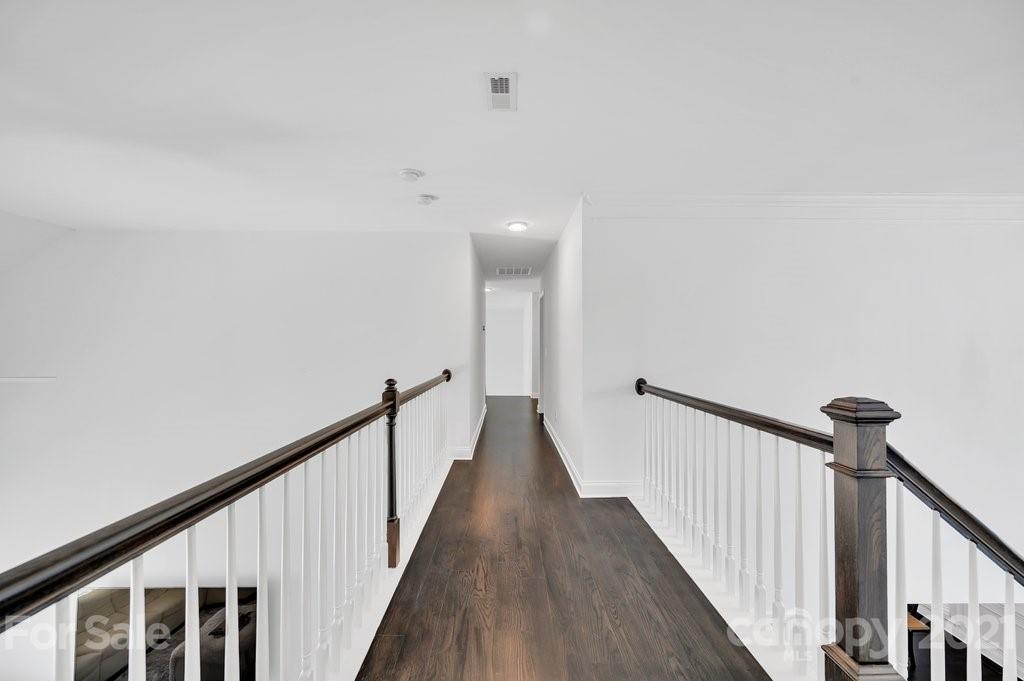 1883 Chestnut Hill Drive Tega Cay, SC 29708 - Photo 24 of 34 a view of a hallway with wooden floor and staircase
