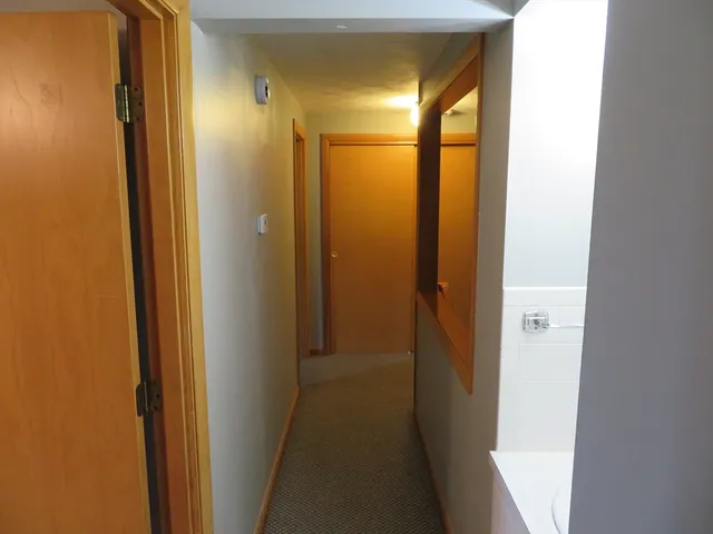 a view of a bathroom from a hallway