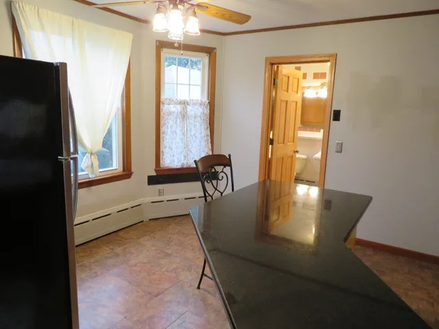 a dining room with furniture and a window