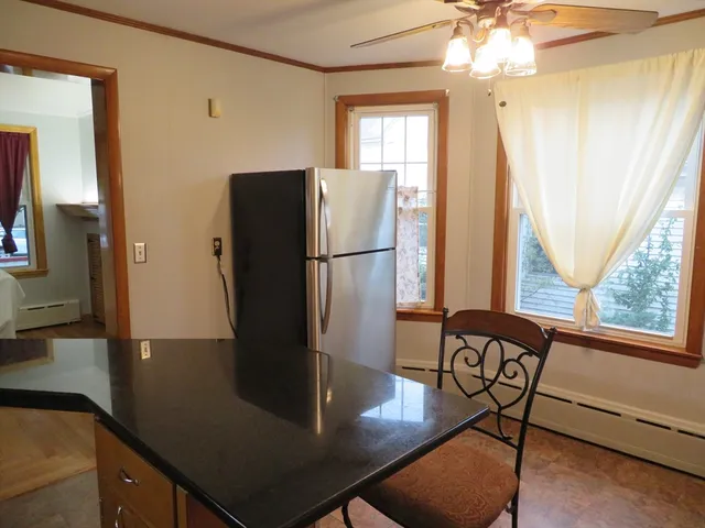 a kitchen with stainless steel appliances granite countertop a refrigerator a stove and a refrigerator