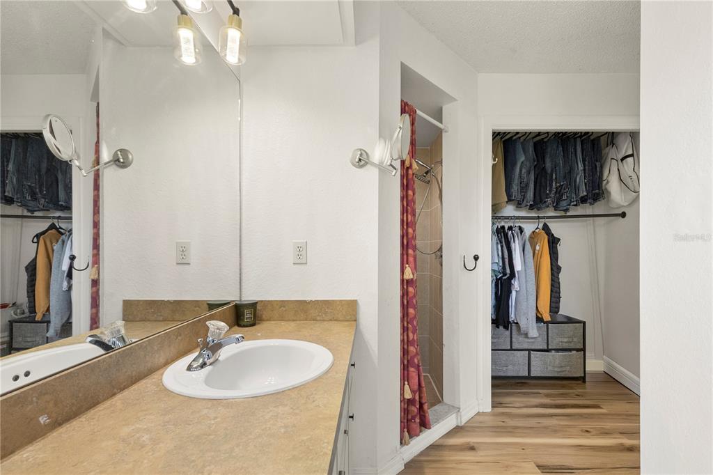 9917 Nelson Road Dade City, FL 33525 - Photo 28 of 40 a bathroom with a sink double vanity and a mirror
