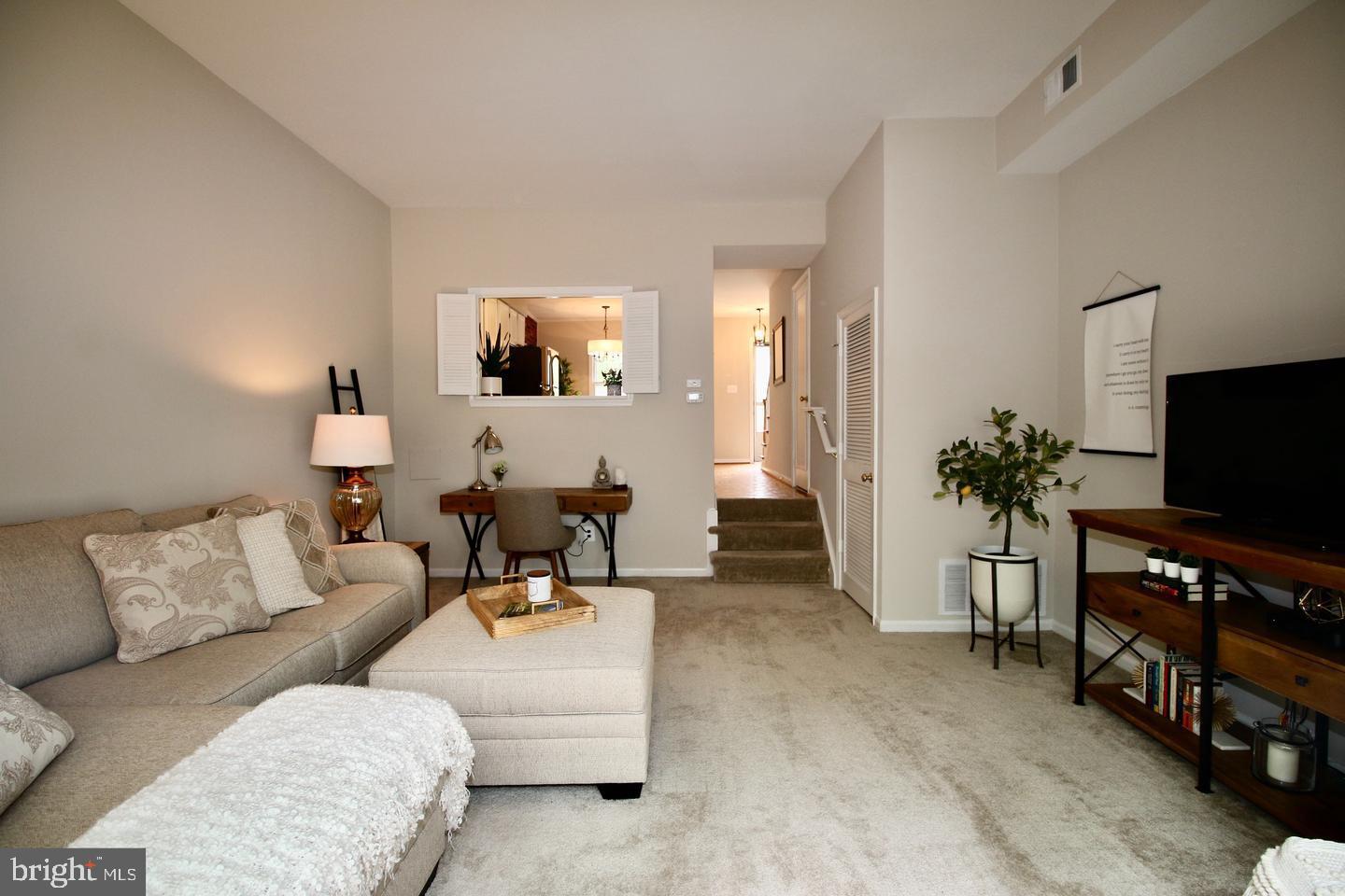 5918 Prince George Drive, Unit 313 Springfield, VA 22152 - Photo 12 of 29 a living room with furniture and a flat screen tv