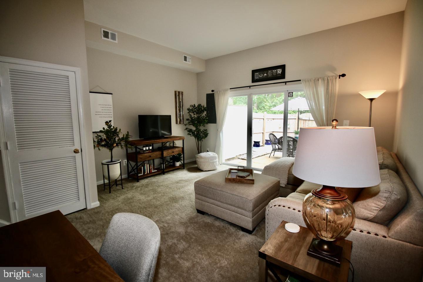 5918 Prince George Drive, Unit 313 Springfield, VA 22152 - Photo 14 of 29 a living room with furniture and a flat screen tv