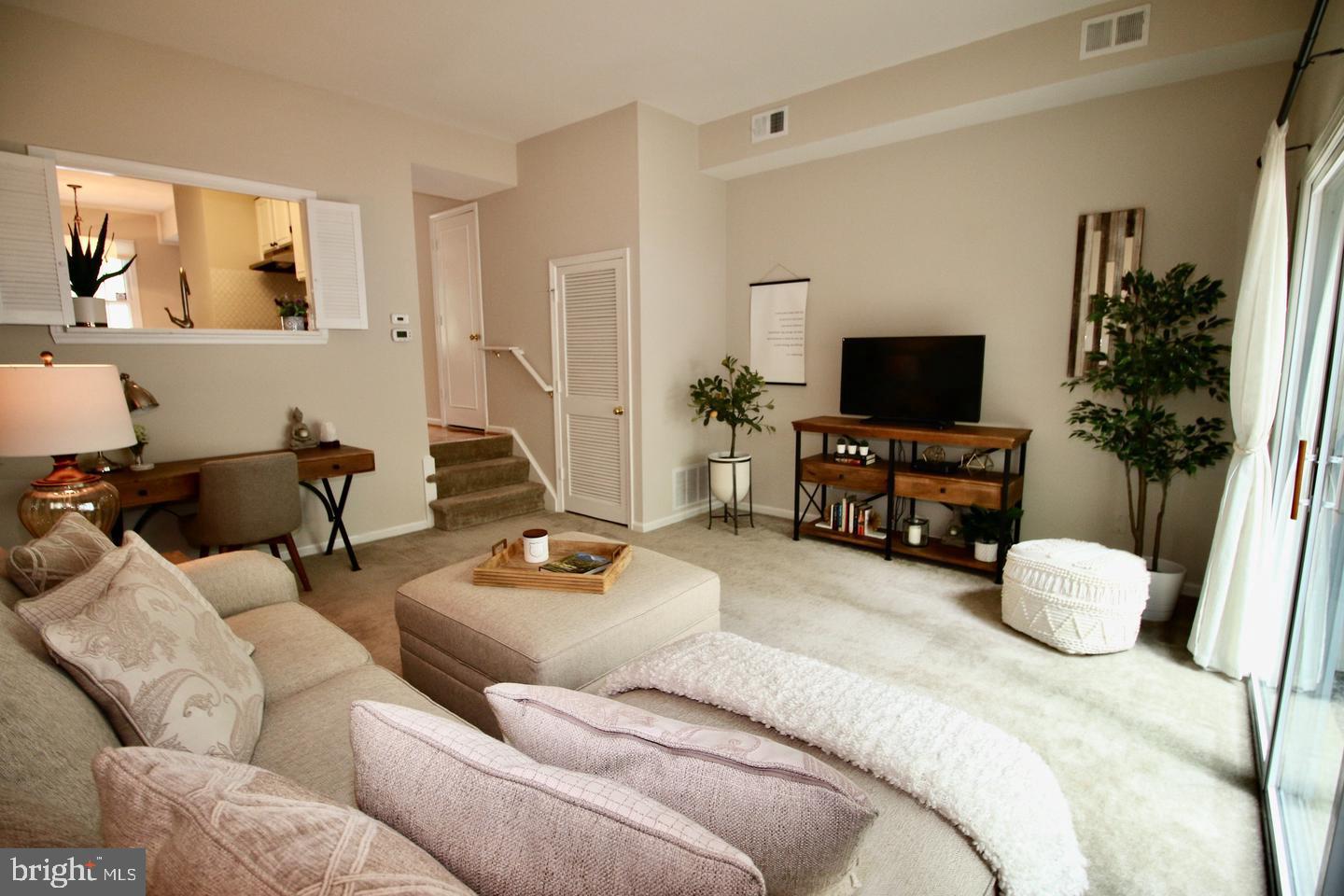 5918 Prince George Drive, Unit 313 Springfield, VA 22152 - Photo 15 of 29 a living room with furniture and a flat screen tv