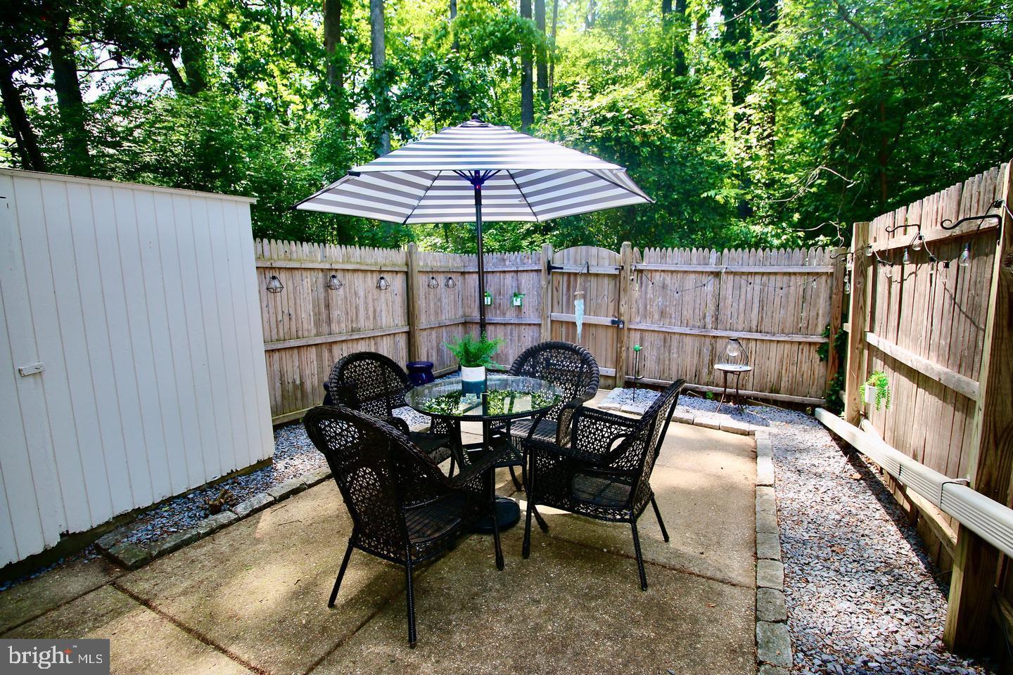5918 Prince George Drive, Unit 313 Springfield, VA 22152 - Photo 20 of 29 a patio table with chairs and an umbrella