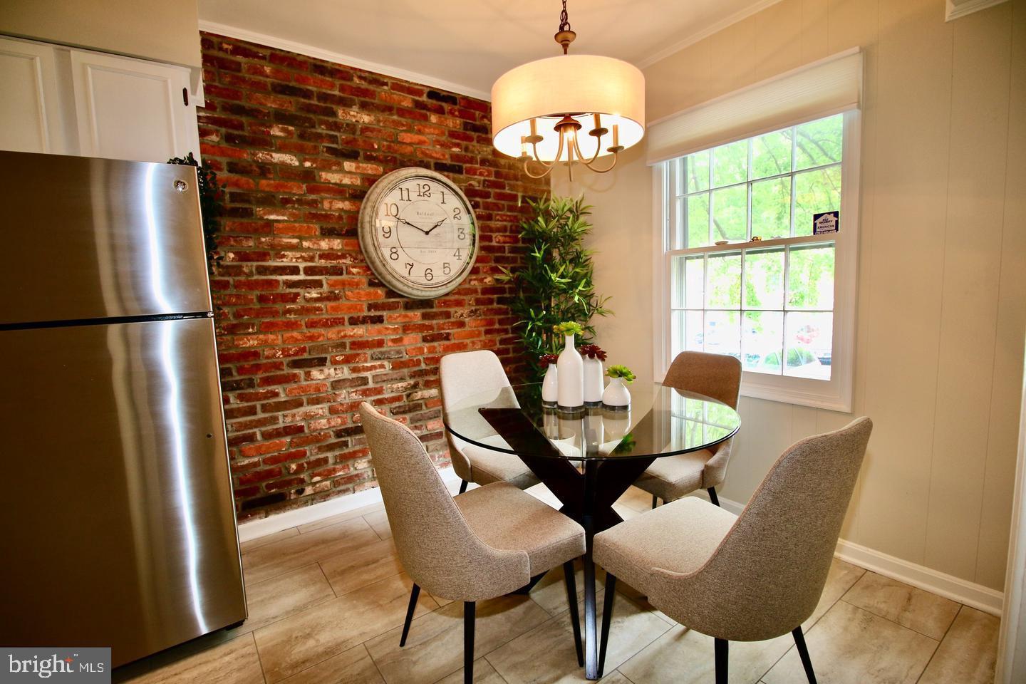 5918 Prince George Drive, Unit 313 Springfield, VA 22152 - Photo 2 of 29 a view of a dining room with furniture window and wooden floor
