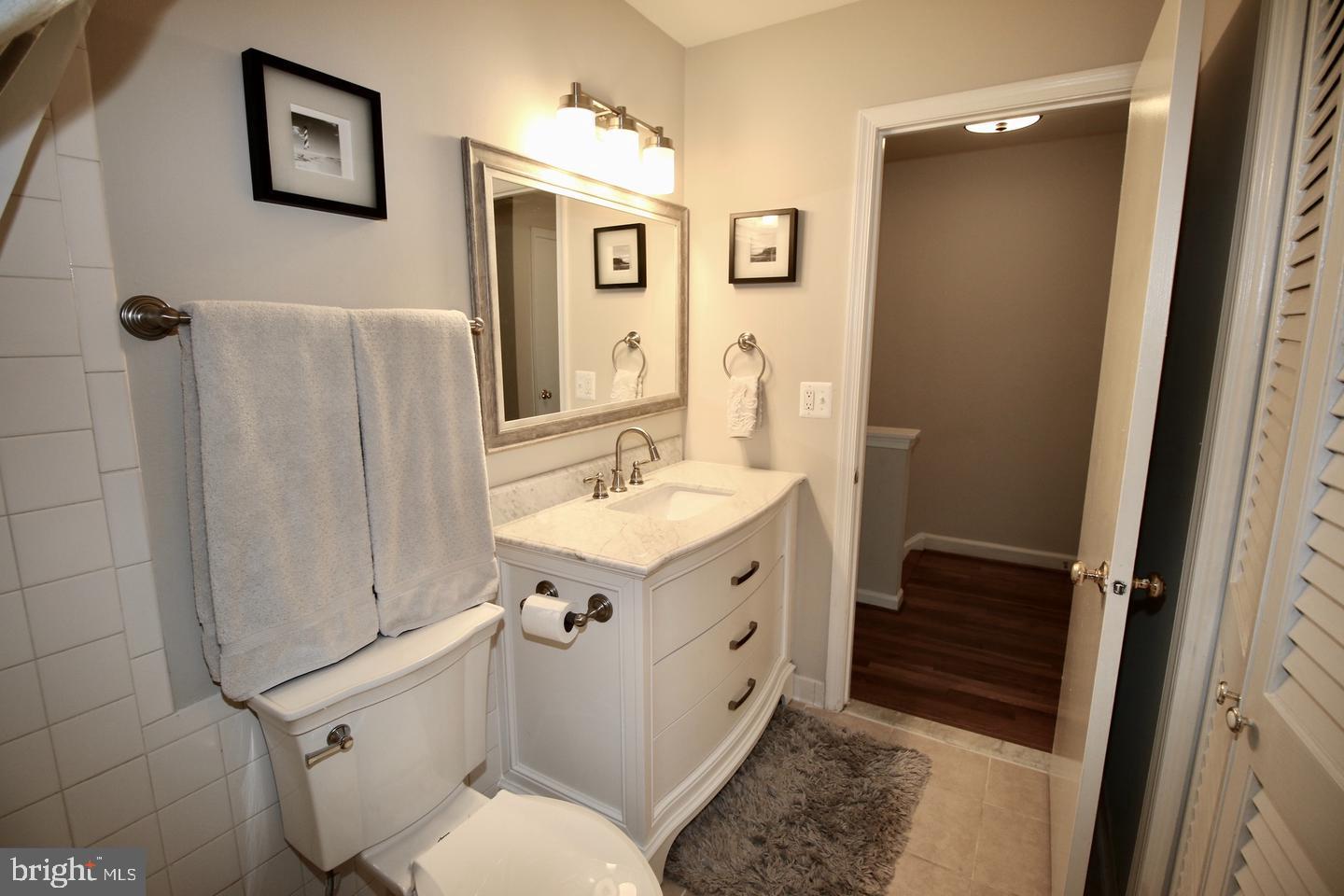 5918 Prince George Drive, Unit 313 Springfield, VA 22152 - Photo 22 of 29 a bathroom with a granite countertop sink toilet and shower