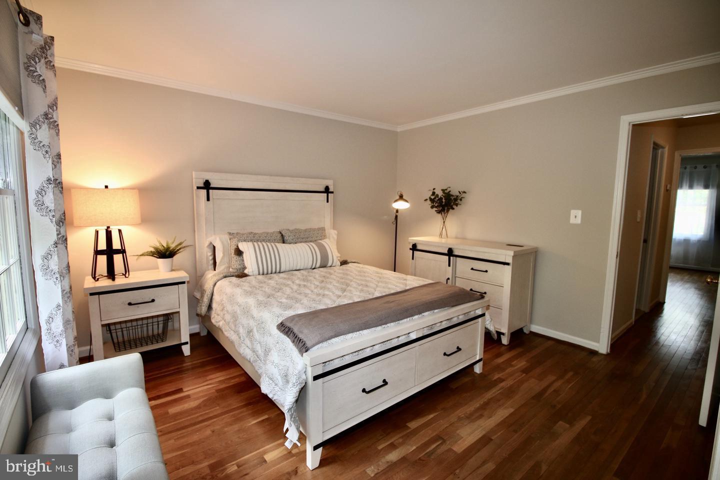 5918 Prince George Drive, Unit 313 Springfield, VA 22152 - Photo 25 of 29 a bedroom with a bed and wooden floor