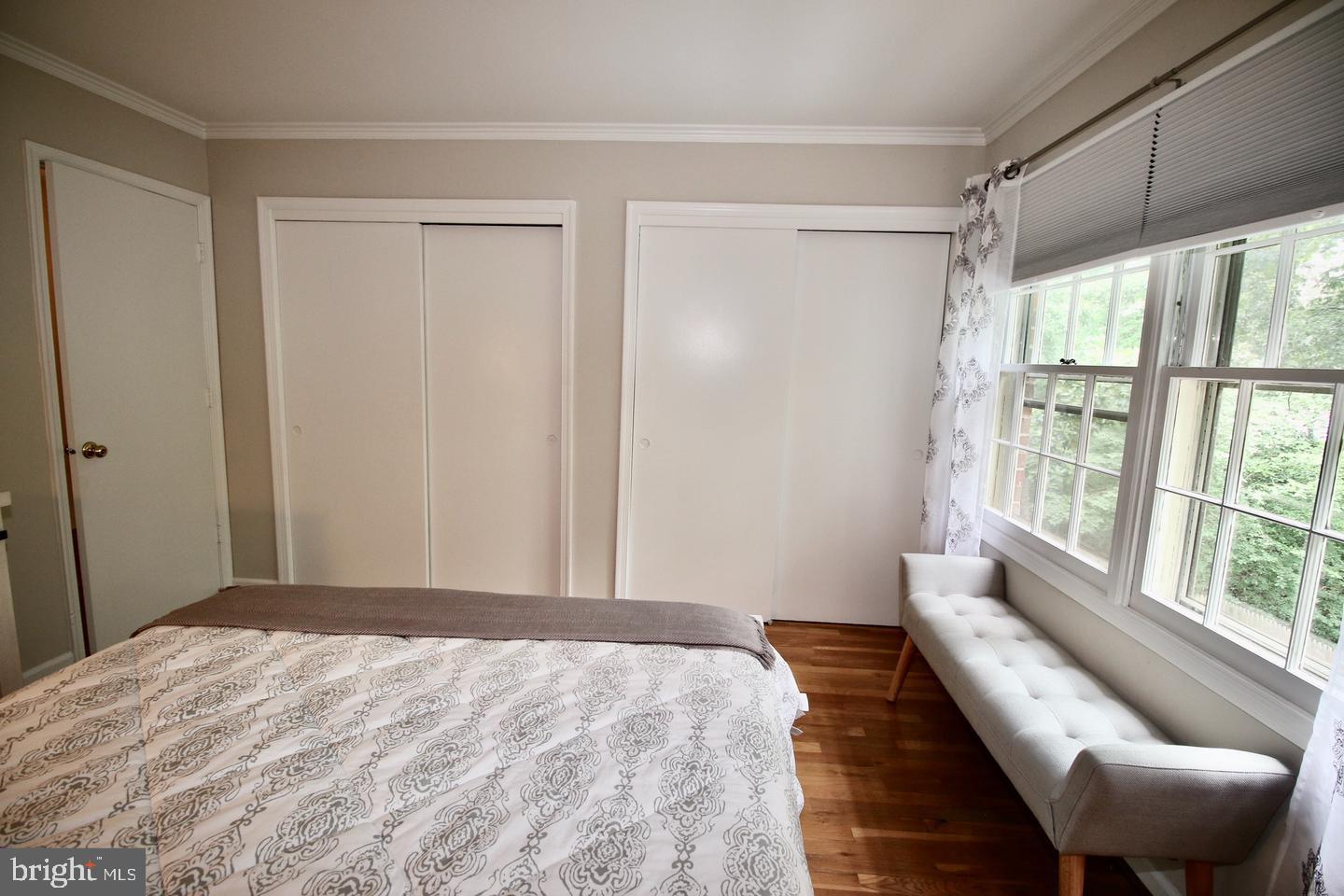 5918 Prince George Drive, Unit 313 Springfield, VA 22152 - Photo 26 of 29 a bedroom with a bed and a large window