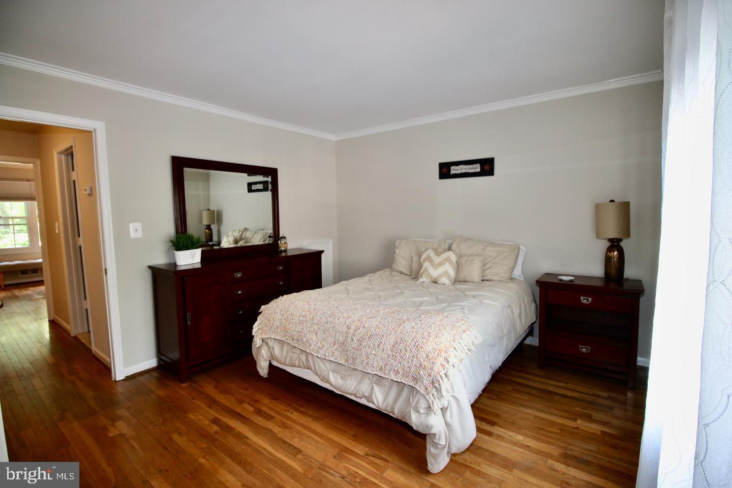 5918 Prince George Drive, Unit 313 Springfield, VA 22152 - Photo 27 of 29 a bedroom with a bed and wooden floor