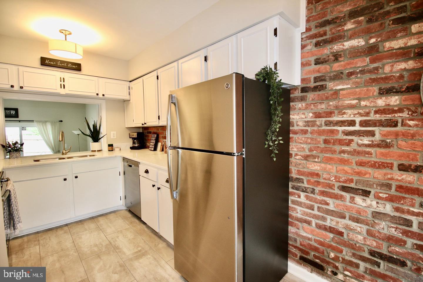 5918 Prince George Drive, Unit 313 Springfield, VA 22152 - Photo 4 of 29 a kitchen with cabinets and stainless steel appliances
