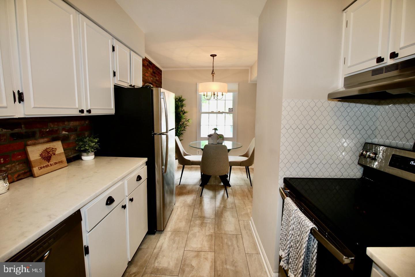 5918 Prince George Drive, Unit 313 Springfield, VA 22152 - Photo 5 of 29 a kitchen with a sink a stove and a refrigerator
