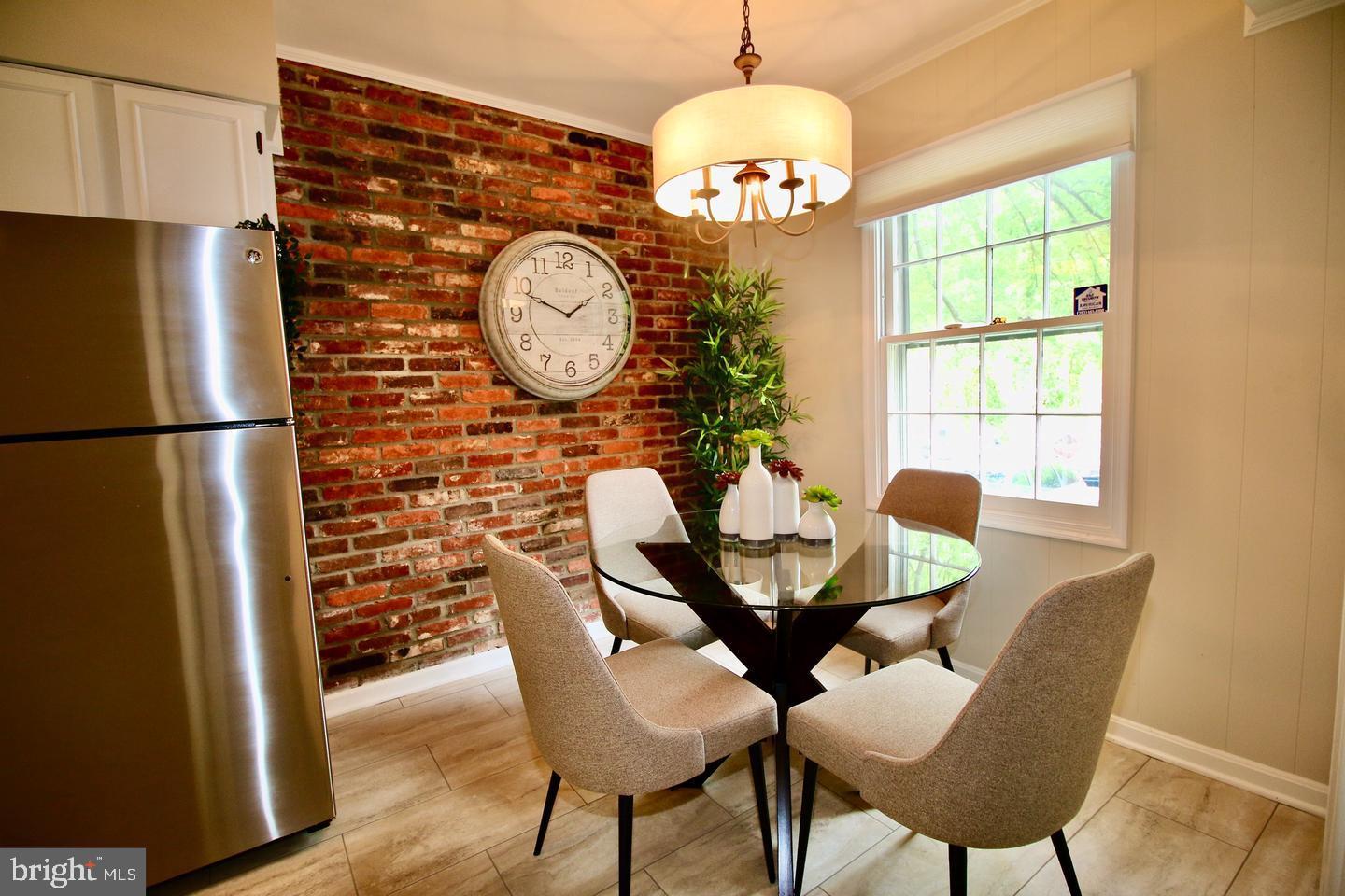 5918 Prince George Drive, Unit 313 Springfield, VA 22152 - Photo 6 of 29 a view of a dining room with furniture a chandelier and wooden floor