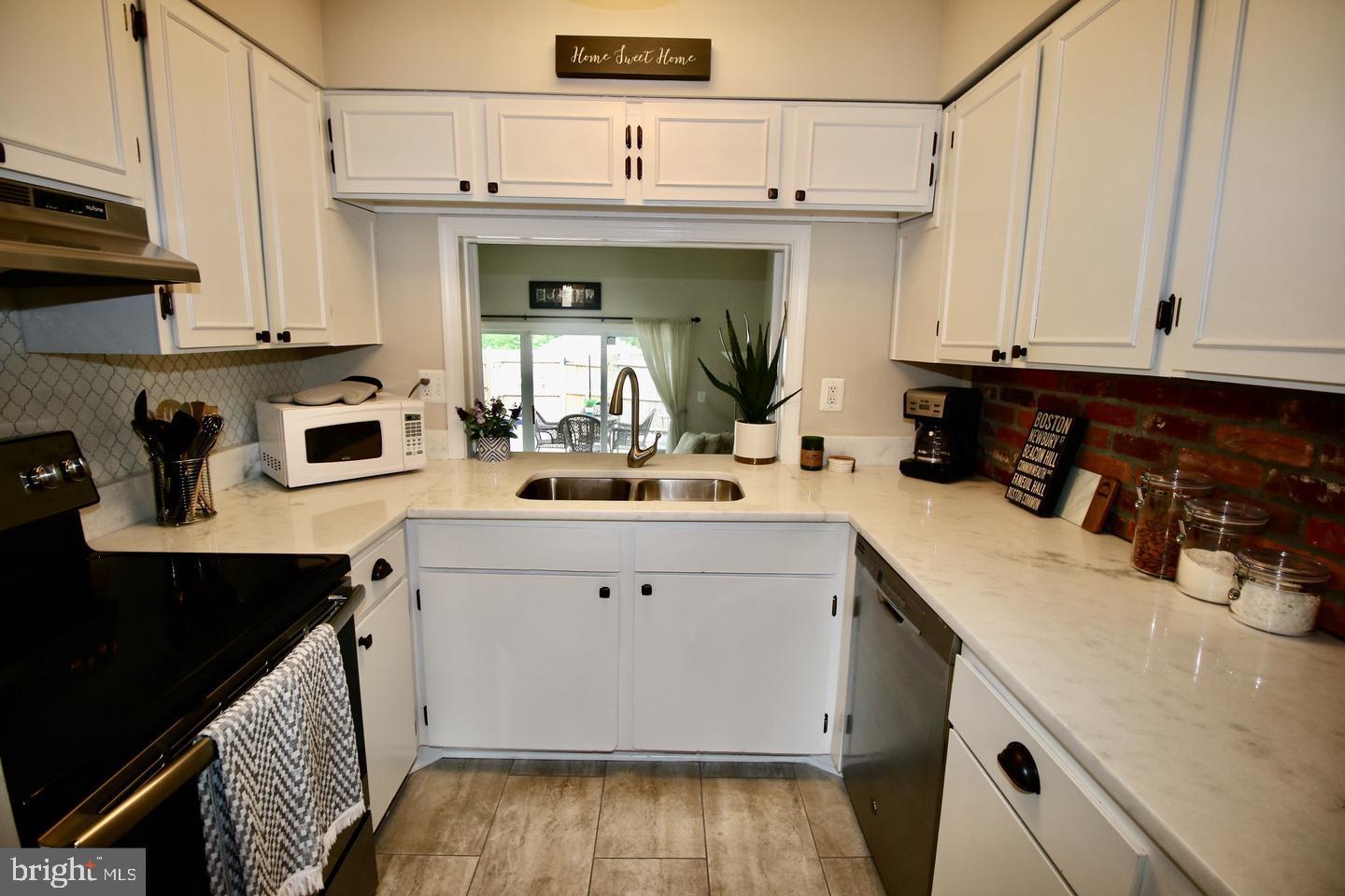 5918 Prince George Drive, Unit 313 Springfield, VA 22152 - Photo 9 of 29 a kitchen with a sink and cabinets