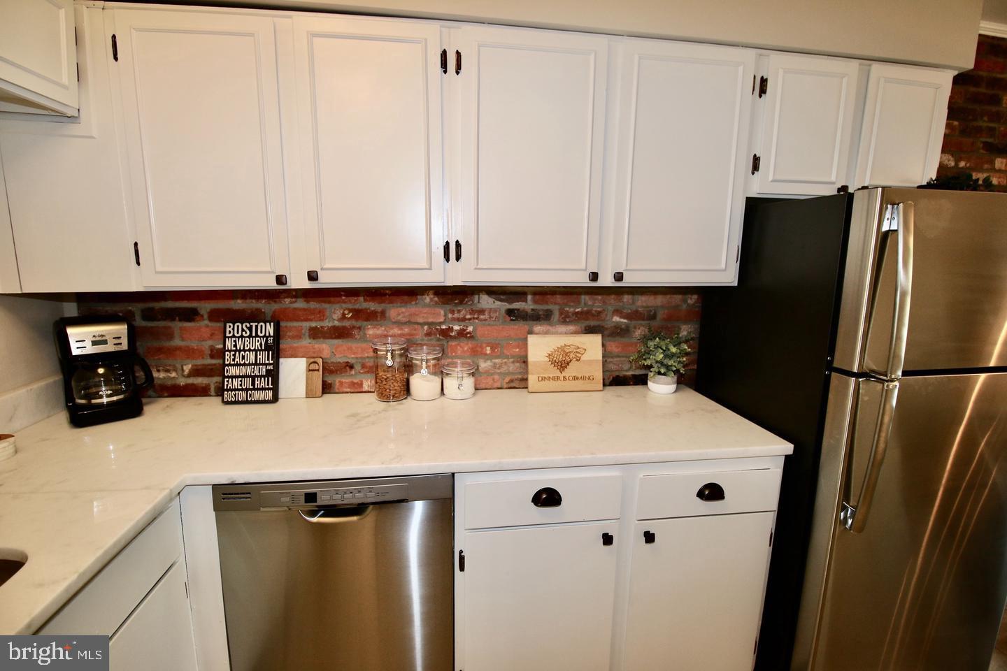 5918 Prince George Drive, Unit 313 Springfield, VA 22152 - Photo 10 of 29 a kitchen with stainless steel appliances a refrigerator a sink a stove and cabinets