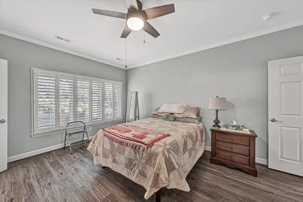 a bathroom with a granite countertop sink a toilet a mirror and shower