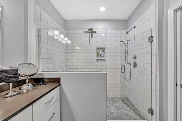 a view of walk in closet with clothes