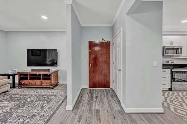 a kitchen with granite countertop a sink a counter top space stainless steel appliances and cabinets