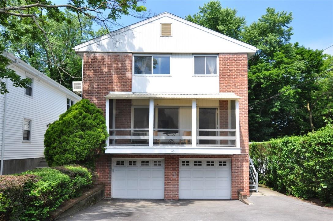 a front view of a house with a garage