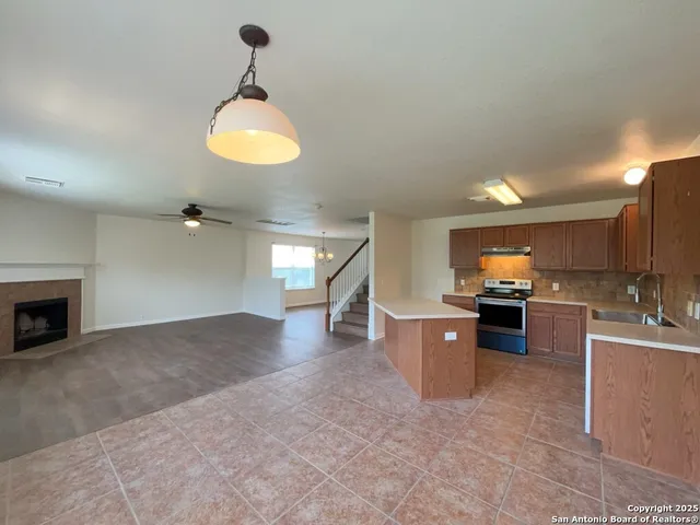 a kitchen with stainless steel appliances a sink stove and cabinets