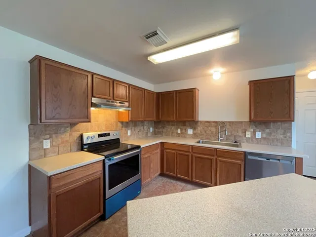 a kitchen with a stove and a microwave