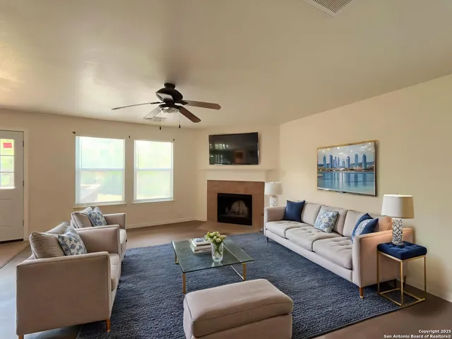 a living room with furniture and a fireplace