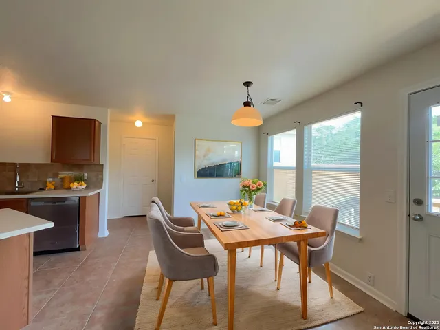 a view of a dining room with furniture and a window