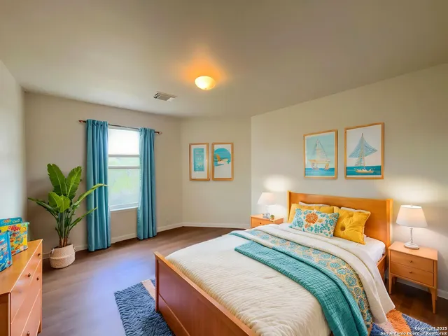 a bedroom with a bed and a potted plant