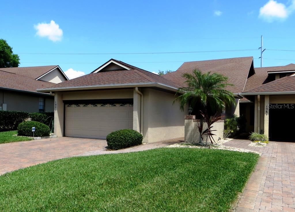 1971 Arbor Way Mount Dora, FL 32757 - Photo 1 of 1 a front view of a house with a garden and yard