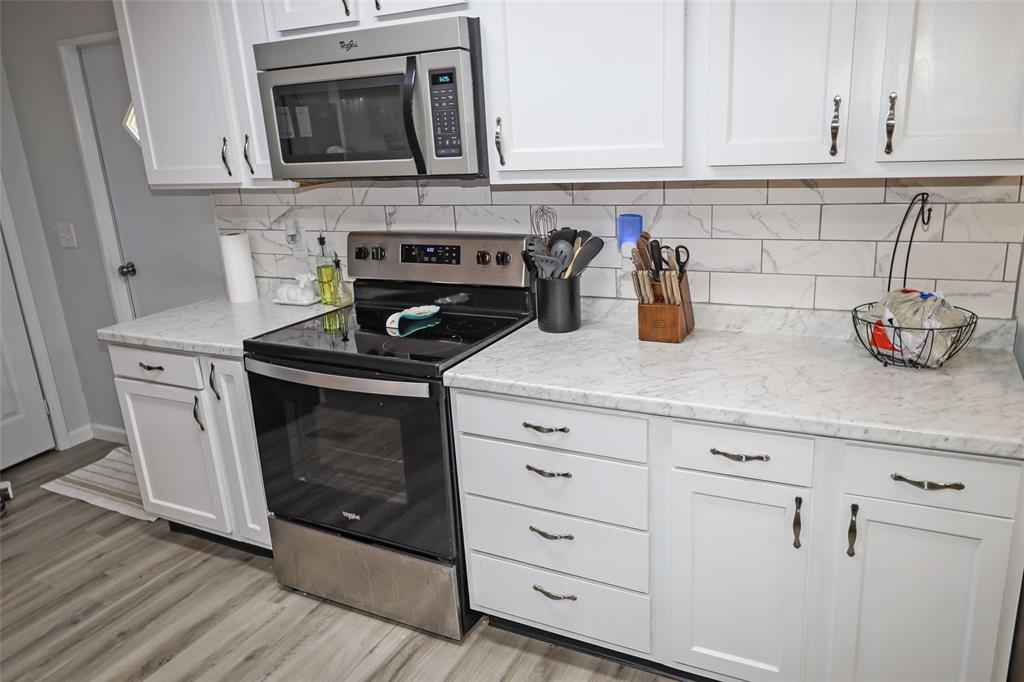 214 Destiny Lane Keatchie, LA 71046 - Photo 15 of 40 a kitchen with stainless steel appliances granite countertop a sink a stove and cabinets