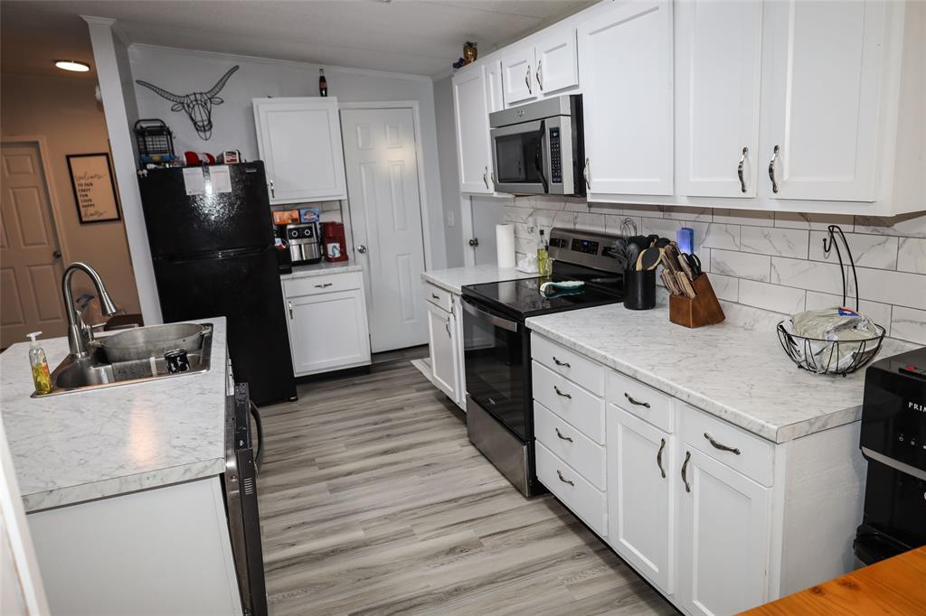 214 Destiny Lane Keatchie, LA 71046 - Photo 16 of 40 a kitchen with stainless steel appliances a stove refrigerator sink and cabinets