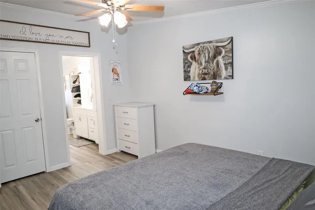 a view of a bedroom with wooden floor