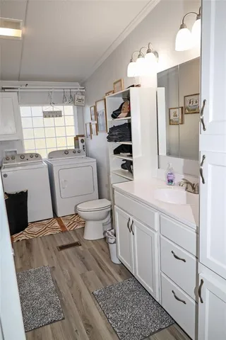 a bathroom with a double vanity sink toilet and mirror