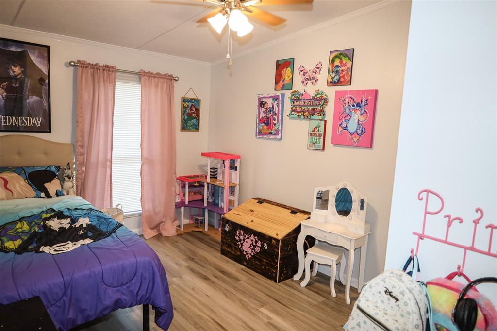 214 Destiny Lane Keatchie, LA 71046 - Photo 24 of 40 a bedroom with furniture and a wooden floor