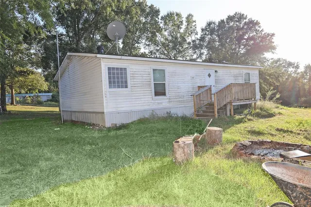a view of backyard with a garden and deck