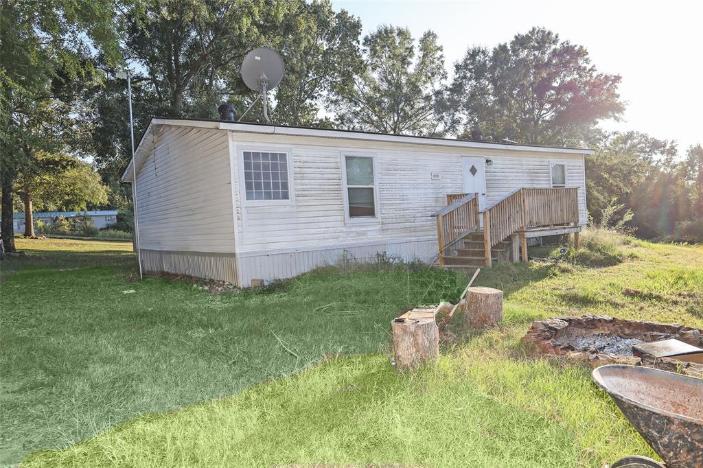 214 Destiny Lane Keatchie, LA 71046 - Photo 30 of 40 a view of backyard with a garden and deck