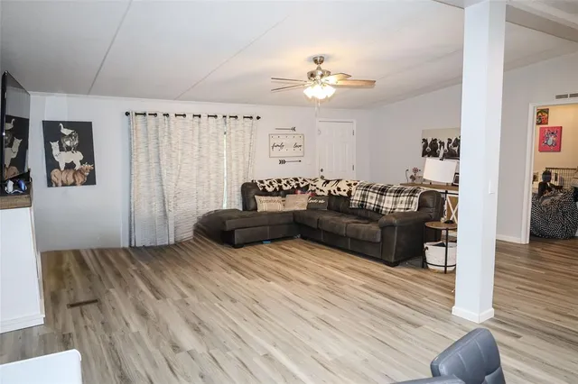 a living room with furniture and wooden floor