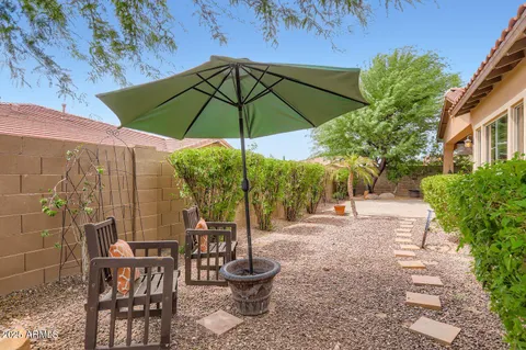 a backyard of a house with table and chairs