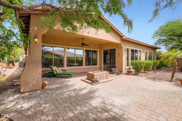 a view of a house with backyard sitting area and porch