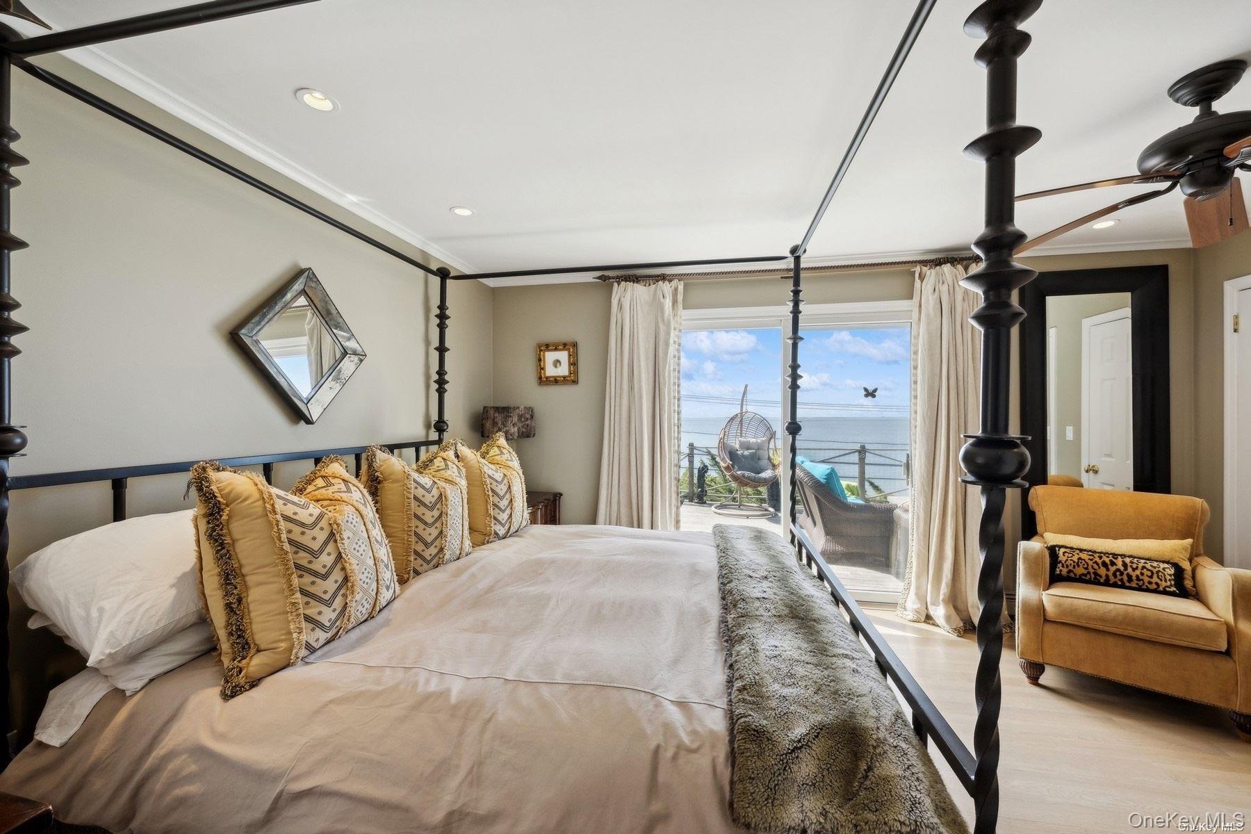 2 West Hillover Road Hampton Bays, NY 11946 - Photo 11 of 42 a bedroom with a large bed and a couch