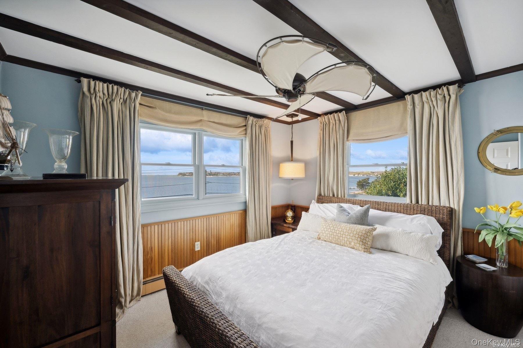 2 West Hillover Road Hampton Bays, NY 11946 - Photo 15 of 42 a bedroom with a large bed and a large window