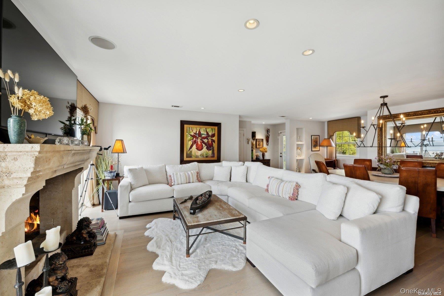 2 West Hillover Road Hampton Bays, NY 11946 - Photo 16 of 42 a living room with furniture and a fireplace