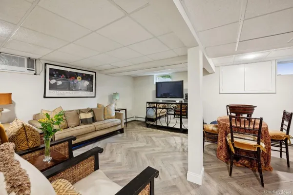 a living room with furniture a piano and a flat screen tv