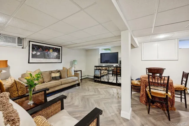 a living room with furniture a piano and a flat screen tv
