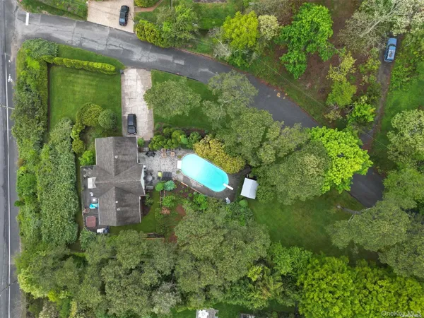 an aerial view of a house with a yard and plants