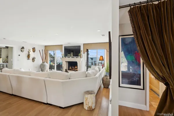 a living room with furniture a fireplace and a painting on the wall