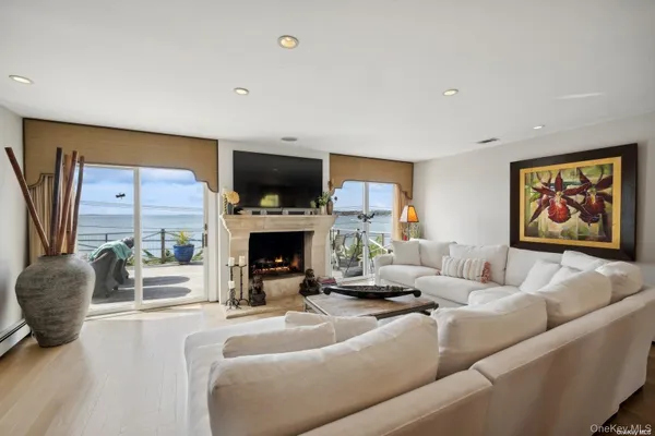 a living room with furniture a fireplace and a flat screen tv