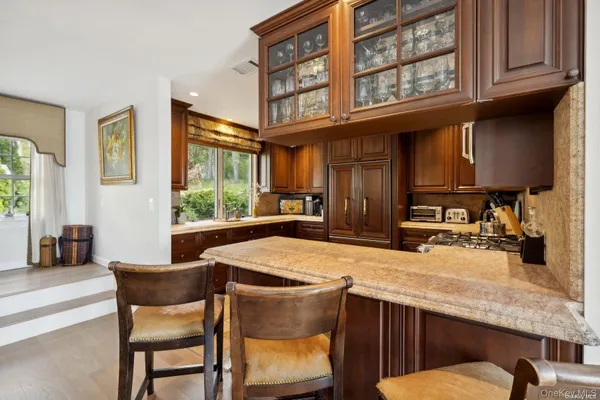 a kitchen with a table chairs cabinets and window