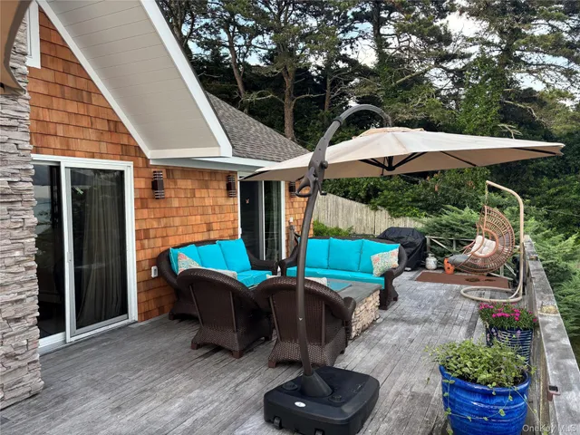 a view of a patio with table and chairs potted plants