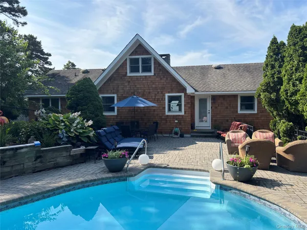 a front view of a house with sitting area
